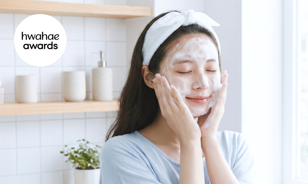 A woman starting her gentle daily skincare routine at home, cleansing her face with a soft foam cleanser