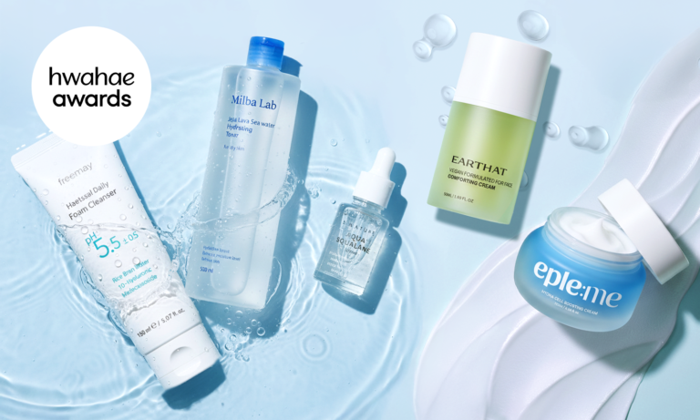 An image of Hwahae Awards–winning hydration skincare products arranged on water. The scene features a mild acidic daily foam cleanser, a Jeju lava seawater hydrating toner, an aqua squalane serum, a vegan comforting face cream, and a hydra cell boosting cream, surrounded by water droplets to highlight Korean hydration skincare and a fresh, dewy routine.