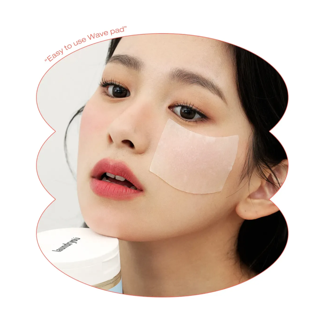 Model applying a Laundryou toner pad on her cheek, showcasing a hydrating and soothing sheet pad designed for easy daily skincare use.