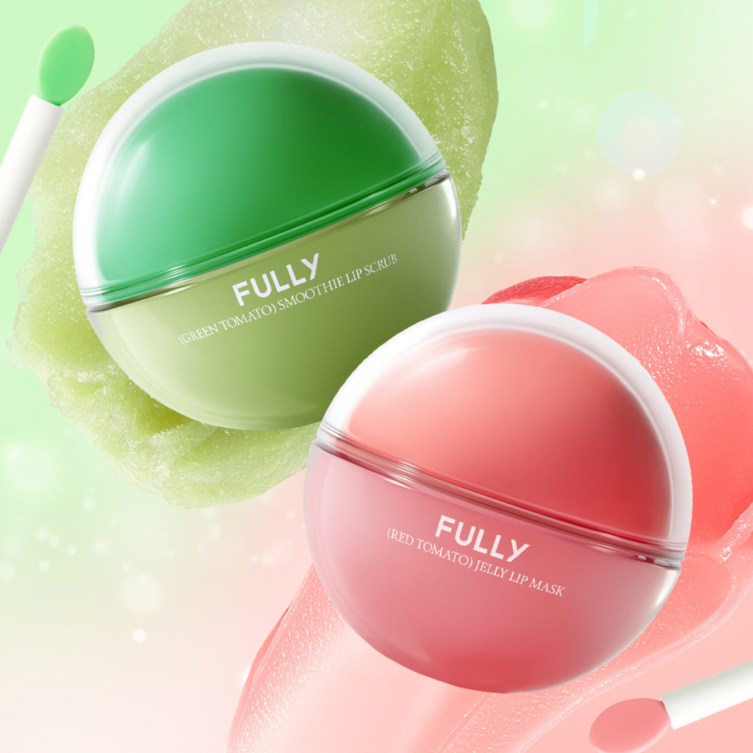 Two round lip care products displayed against a soft, fresh background. The green container is a “Green Tomato Smoothie Lip Scrub,” and the pink container is a “Red Tomato Jelly Lip Mask.” Both appear with glossy gel and scrub textures, highlighting their hydrating and exfoliating benefits.
