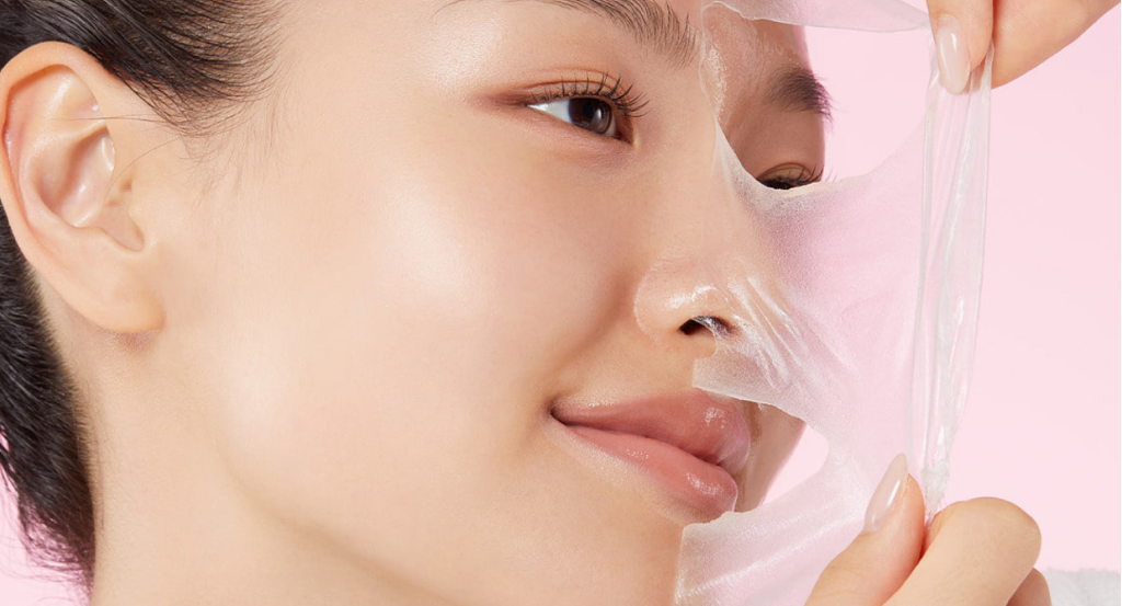 A close-up of a woman removing a hydrogel collagen face mask, showing smooth, hydrated skin after overnight care.