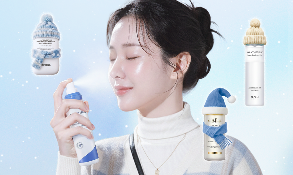 A woman gently sprays facial mist onto her skin against a winter-inspired background, creating a dewy, hydrated glow. Korean skincare face mist products focused on hydration and soothing are displayed around her, representing a daily facial mist routine that protects the skin barrier during cold weather.